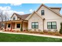 Detailed view of the new home with brick and siding exterior, covered porch and professional landscaping at 317 Boyd Rd, Clover, SC 29710