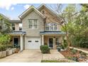 Attractive townhome with stone accents, a front porch, and meticulously maintained landscaping at 3414 Chagall Ct, Charlotte, NC 28205
