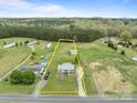 Wide aerial shot of the property showing the house, expansive lot, and surrounding landscape at 34958 Lowder Rd, New London, NC 28127