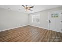 Empty room with natural light, new flooring and a ceiling fan, ideal for customization at 423 Pleasant Ave, Kannapolis, NC 28081