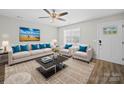 Bright living room featuring modern furnishings, neutral color scheme, and ceiling fan at 423 Pleasant Ave, Kannapolis, NC 28081