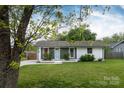 Beautiful home with lush greenery and a well-kept lawn, showcasing its inviting curb appeal at 4244 Donnybrook Pl, Charlotte, NC 28205