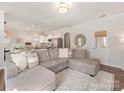 Bright, open-concept living area with a comfortable sectional sofa and seamless access to the kitchen at 4303 Patriots Hill Rd, Mint Hill, NC 28227