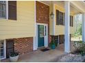 Inviting front entrance with brick accents, covered porch, and a stylish teal front door at 5451 Gunpowder Dr, Hickory, NC 28601