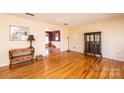 Bright living room featuring hardwood floors, vintage furniture, and an open layout at 5451 Gunpowder Dr, Hickory, NC 28601