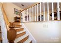 Classic staircase with wooden banister and white balusters, leading to the upper level at 5451 Gunpowder Dr, Hickory, NC 28601
