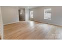 Bright living room with light wood floors, neutral paint, and lots of natural light at 615 Billingsley Rd, Charlotte, NC 28211