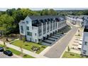 Aerial view of modern townhomes, showing roof top decks, private garages, and surrounding green space at 648 W End Dr, Charlotte, NC 28208