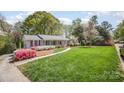 Charming single-story home with inviting porch, lush lawn, and colorful landscaping enhancing curb appeal at 726 Grandview Ne Dr, Concord, NC 28025