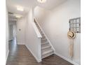 Bright hallway with hardwood floors, leading to a staircase and other rooms at 7445 Abigail Glen Dr, Charlotte, NC 28212