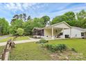Well-maintained home features a convenient carport, mature landscaping, and a welcoming exterior at 8301 Washington Blvd, Charlotte, NC 28262