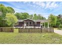 Charming single-story home with a fenced yard, mature trees, and a welcoming exterior at 8301 Washington Blvd, Charlotte, NC 28262
