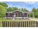 Cozy single-story home with a charming front porch, fenced yard, and inviting curb appeal at 8301 Washington Blvd, Charlotte, NC 28262