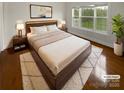 Cozy bedroom showcasing a plush bed, stylish decor, and a bright window overlooking a serene outdoor view at 8929 Meadow Vista Rd, Charlotte, NC 28213