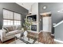 Cozy living room with modern fireplace, TV, and a white sofa near a bright window at 9052 Meadowmont View Dr, Charlotte, NC 28269