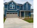 Two-story home showcases a blue exterior, a two-car garage and a well-manicured front lawn at 13737 Roderick Dr # 186, Huntersville, NC 28078