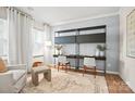 Bright home office with stylish shelving, desks, a patterned rug, and a comfortable chair at 15019 Meadows Hunt Ln # 163, Huntersville, NC 28078