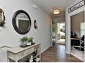 Inviting foyer featuring hardwood floors, decorative mirror, and a view into the home office at 15035 Ockeechobee Ct, Mint Hill, NC 28227