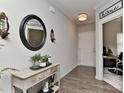 Inviting foyer featuring hardwood floors, decorative mirror, and a view into the home office at 15035 Ockeechobee Ct, Mint Hill, NC 28227