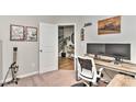 Functional home office with a large desk, dual monitors, and view into the front foyer at 15035 Ockeechobee Ct, Mint Hill, NC 28227