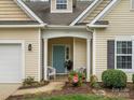 Inviting front entrance with a blue door, white pillars, and seating at 1669 Beleek Ridge Ln, Clover, SC 29710