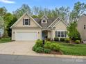Beautiful home featuring a well-kept lawn, an attached garage, and welcoming curb appeal at 1669 Beleek Ridge Ln, Clover, SC 29710