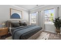 Relaxing bedroom showcasing neutral tones, a comfortable bed, and bright, sunlit windows at 18013 Aura Mist Way # 183, Huntersville, NC 28078
