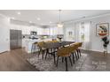 Bright dining area featuring modern furniture, a stylish rug, and an abundance of natural light at 18013 Aura Mist Way # 183, Huntersville, NC 28078