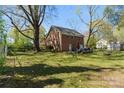 Expansive backyard featuring a well-maintained lawn, patio, and mature trees at 206 23Rd Nw St, Hickory, NC 28601