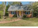 Lovely brick home with a welcoming yellow front door and neatly manicured lawn at 206 23Rd Nw St, Hickory, NC 28601