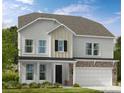 Two-story home featuring stone accents, a two-car garage and welcoming front porch at 2212 Indigo Branch Rd, Indian Land, SC 29707