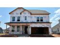 New construction home features a two-car garage and large windows, covered in Tyvek wrap at 2212 Indigo Branch Rd, Indian Land, SC 29707