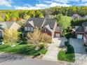 Aerial view of a beautiful brick home with a spacious yard, driveway, and lush green surroundings at 2610 Mchanna Pt, Fort Mill, SC 29708