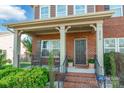 Inviting front porch with classic columns, decorative plants, and a welcoming entrance to the home at 2610 Mchanna Pt, Fort Mill, SC 29708