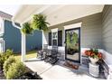 Inviting front porch with rocking chairs, potted plants, and a decorative wreath on the front door at 325 Crandon Rd, Mount Holly, NC 28120