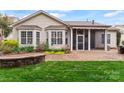Well-maintained backyard with a screened-in porch, stone patio, and flower garden at 331 Miners Cove Way, Fort Mill, SC 29708
