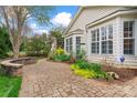 Beautiful backyard featuring a curved stone patio, mature trees, and well-manicured landscaping at 331 Miners Cove Way, Fort Mill, SC 29708