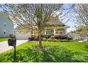 Traditional-style home featuring a well-manicured lawn, mature trees, and an inviting front porch at 4006 Fall Oak Ter, Fort Mill, SC 29707