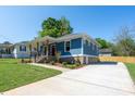 Inviting craftsman-style home with a covered porch, spacious driveway, and well-maintained lawn, perfect for outdoor living at 406 Williamson St, Fort Mill, SC 29715