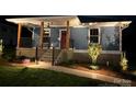 Charming craftsman-style home featuring a welcoming front porch and manicured landscaping, illuminated at night at 406 Williamson St, Fort Mill, SC 29715