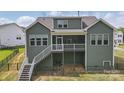 Elevated back deck with a screened in porch, stair access and lower-level basement access at 4120 Spring Cove Way, Belmont, NC 28012