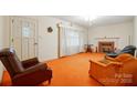 Spacious living room featuring a fireplace, neutral walls, and unique orange carpeting at 422 Sherrill Farm Rd, Lincolnton, NC 28092