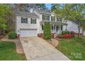 Two-story home with a well-maintained lawn, two-car garage, and inviting front porch and walkway at 5225 Mcchesney Dr, Charlotte, NC 28269