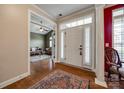 Warm and welcoming foyer with hardwood floors and view into the living room at 615 Reliance Ct, Tega Cay, SC 29708