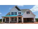 Charming two-story home with white siding, black shutters, and covered porch at 6707 Baker Creek Ave, Indian Land, SC 29707