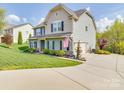 Beautiful home with an attached garage, long driveway, and lush, green lawn at 7138 Dove Field Ln, Indian Land, SC 29707