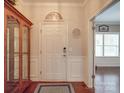 Inviting entryway featuring hardwood floors, a front door, and decorative accents at 7138 Dove Field Ln, Indian Land, SC 29707