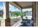Relaxing back porch with comfortable seating and a view of the lush backyard at 8313 Balcony Bridge Rd, Huntersville, NC 28078