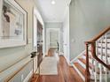 Welcoming foyer with hardwood floors, elegant staircase, and modern decor for a sophisticated entry at 8623 Tullamore Park Cir, Charlotte, NC 28226
