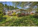 A serene backyard view with a mix of plants and flowers, complemented by a cozy wooden deck at 8974, 8972 & 8970 Nc 90 E Hwy, Stony Point, NC 28678